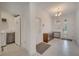 Bright entryway with tile floors, hall tree, and a view into the laundry room at 7651 Five Oaks Dr, Harmony, FL 34773