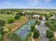 Gorgeous aerial showcasing the community golf course and lake from an elevated view on a bright, sunny day at 7651 Five Oaks Dr, Harmony, FL 34773