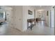 Neutral hallway with tile flooring leading to various rooms in the house at 7651 Five Oaks Dr, Harmony, FL 34773