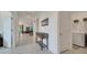 Hallway featuring tile floors and neutral paint leading to the open living area at 7651 Five Oaks Dr, Harmony, FL 34773