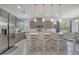 Modern kitchen with gray cabinets, stainless steel appliances, and a large center island at 7651 Five Oaks Dr, Harmony, FL 34773