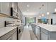 Stylish kitchen with stainless appliances, granite countertops, and an open view to the dining area at 7651 Five Oaks Dr, Harmony, FL 34773