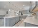 Bright kitchen with a large island, stainless steel appliances, and ample cabinet space at 7651 Five Oaks Dr, Harmony, FL 34773