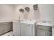 Convenient laundry room featuring modern washer, dryer, and ample counter space at 7651 Five Oaks Dr, Harmony, FL 34773