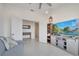 Open living room with French doors, media center, and comfortable sofa at 7651 Five Oaks Dr, Harmony, FL 34773