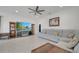 Comfortable living room with large TV, neutral tones, ceiling fan, and plenty of seating at 7651 Five Oaks Dr, Harmony, FL 34773