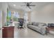 Home office featuring neutral walls, tiled floors, a ceiling fan, and comfortable seating area at 7651 Five Oaks Dr, Harmony, FL 34773