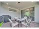 Screened patio with brick flooring, patio furniture and views of the backyard at 7651 Five Oaks Dr, Harmony, FL 34773