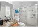 Bathroom featuring a shower with glass doors, granite counters, and a vanity with a sink at 841 Oaks Shores Rd, Leesburg, FL 34748