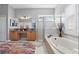 Bright bathroom with double sink vanity, soaking tub, walk-in shower, and modern fixtures at 841 Oaks Shores Rd, Leesburg, FL 34748
