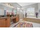 Bright bathroom with double sink vanity, soaking tub, walk-in shower, and modern fixtures at 841 Oaks Shores Rd, Leesburg, FL 34748