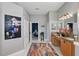 Bathroom leading to main bedroom with double sink vanity, artwork, and rug at 841 Oaks Shores Rd, Leesburg, FL 34748