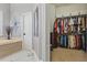 Bathroom and walk-in closet with tub, tile flooring, and natural light at 841 Oaks Shores Rd, Leesburg, FL 34748