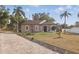 Attractive home with stone detailing, mature landscaping, and a brick paver driveway for added curb appeal at 841 Oaks Shores Rd, Leesburg, FL 34748