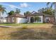 Inviting home with stone accents, well-manicured lawn, and double door entry, creating an inviting ambiance at 841 Oaks Shores Rd, Leesburg, FL 34748
