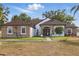 Charming single-story home with stone accents, a well-manicured lawn, and a welcoming entrance at 841 Oaks Shores Rd, Leesburg, FL 34748