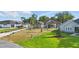 Charming single-story home with a manicured lawn, lush landscaping, and a long driveway at 841 Oaks Shores Rd, Leesburg, FL 34748