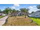 Charming single-story home with a stone and stucco exterior, fresh landscaping, and a long driveway at 841 Oaks Shores Rd, Leesburg, FL 34748