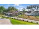 Charming single-story home with a stone and stucco exterior, mature trees, and a long driveway at 841 Oaks Shores Rd, Leesburg, FL 34748