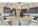 This kitchen features navy cabinets, stainless steel appliances and a counter-height island with chairs at 841 Oaks Shores Rd, Leesburg, FL 34748