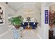 Elegant living room with high ceilings, marble floors, stylish furniture, and decorative plants at 841 Oaks Shores Rd, Leesburg, FL 34748