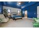 Spacious main bedroom boasts a blue accent wall, a fan, and a seating area at 841 Oaks Shores Rd, Leesburg, FL 34748