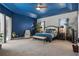 Spacious main bedroom featuring a blue accent wall and tray ceiling with a ceiling fan at 841 Oaks Shores Rd, Leesburg, FL 34748