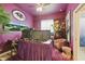 Bold purple office with multiple monitors, a Baltimore Ravens sign, and a cozy seating area at 841 Oaks Shores Rd, Leesburg, FL 34748