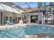 Screened pool and patio create a private outdoor space for relaxation and entertainment at 841 Oaks Shores Rd, Leesburg, FL 34748