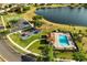 Aerial view of a community featuring a pool, playground, parking and a lake at 9020 Breezy Meadow Way, Orlando, FL 32829