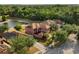 Aerial view of the homes, landscaping, and lake at 9020 Breezy Meadow Way, Orlando, FL 32829