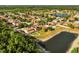 Residential neighborhood featuring a lake, mature trees, and manicured lawns at 9020 Breezy Meadow Way, Orlando, FL 32829
