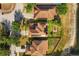 Aerial view of the house highlighting the roof, yard, and lake at 9020 Breezy Meadow Way, Orlando, FL 32829
