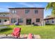 Expansive backyard with lush green grass, outdoor seating, and serene views of the surrounding landscape at 9020 Breezy Meadow Way, Orlando, FL 32829