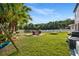 Spacious backyard with lush lawn, pond view, and outdoor seating, perfect for relaxation and recreation at 9020 Breezy Meadow Way, Orlando, FL 32829