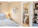 Bedroom leads to a bathroom with wood cabinets, a toilet, and a tiled shower/tub at 9020 Breezy Meadow Way, Orlando, FL 32829