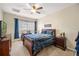 Comfortable bedroom featuring a ceiling fan, study desk, and well-lit window offering a cozy retreat at 9020 Breezy Meadow Way, Orlando, FL 32829