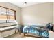 Bright bedroom with a window desk and a comfortable bed, providing an ideal space for rest and productivity at 9020 Breezy Meadow Way, Orlando, FL 32829