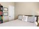 Cozy bedroom with neutral decor, side table and decoratively pillowed bed at 9020 Breezy Meadow Way, Orlando, FL 32829