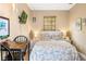 Cozy bedroom featuring a queen bed, a small workspace, and neutral walls at 9020 Breezy Meadow Way, Orlando, FL 32829