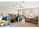 Bright bedroom features carpet flooring, office space, comfortable bed, and cozy seating at 9020 Breezy Meadow Way, Orlando, FL 32829