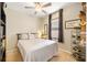 Cozy bedroom with neutral decor, ceiling fan, and window at 9020 Breezy Meadow Way, Orlando, FL 32829