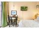 Comfortable bedroom has a small table with seating and is decorated with cozy accents at 9020 Breezy Meadow Way, Orlando, FL 32829