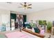 Carpeted bedroom features eclectic decor, work space, and large bed at 9020 Breezy Meadow Way, Orlando, FL 32829