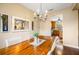 Dining area featuring a rustic wooden table, chandelier, and access to the kitchen at 9020 Breezy Meadow Way, Orlando, FL 32829