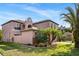 Attractive exterior of a two-story home featuring a well-maintained lawn and mature palm trees at 9020 Breezy Meadow Way, Orlando, FL 32829