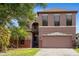 Charming two-story home with a well-maintained lawn and a two car garage at 9020 Breezy Meadow Way, Orlando, FL 32829
