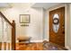 Foyer features a wooden door with decorative glass, tile flooring, and staircase to the second floor at 9020 Breezy Meadow Way, Orlando, FL 32829