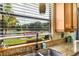 Kitchen with granite countertops, double sinks, and a large window with a serene lake view at 9020 Breezy Meadow Way, Orlando, FL 32829