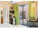 Cozy kitchenette with appliances opening to a private brick patio with outdoor seating at 9020 Breezy Meadow Way, Orlando, FL 32829